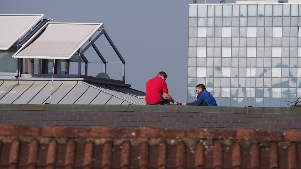 two men on top of the roof